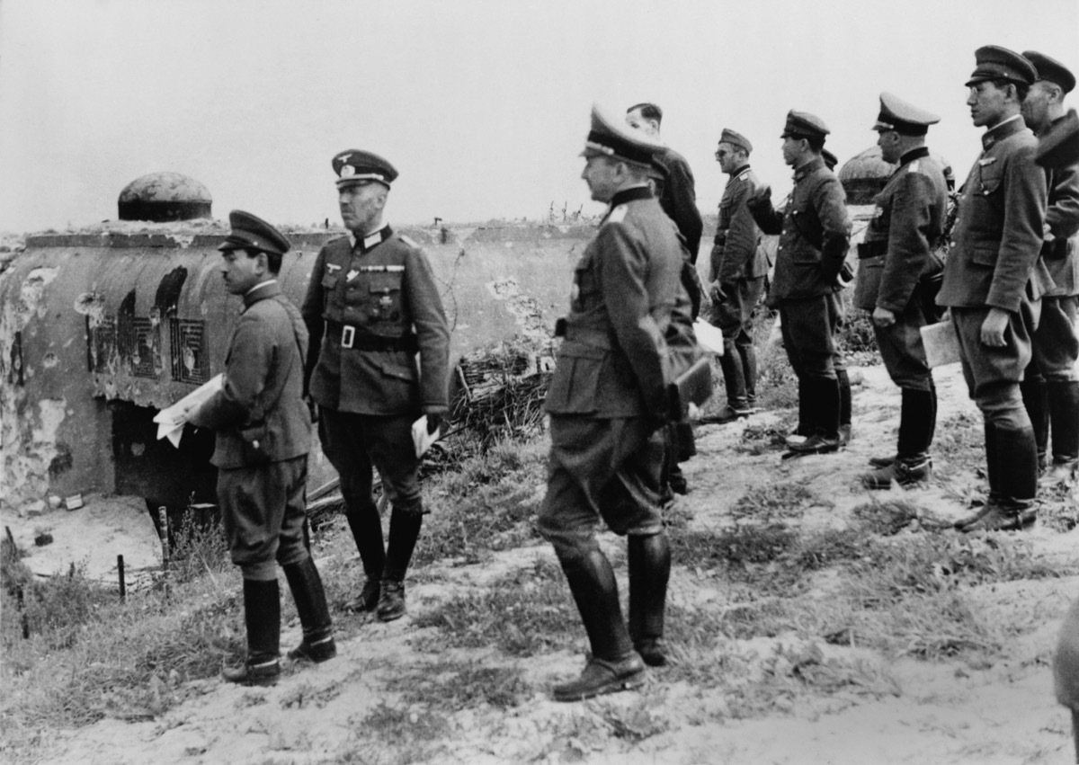 Japanese officers inspect Maginot Line, after the German defeat of France in World War 2. They inspect the damaged entrance to the elaborate fortifications at Schoenenbourg. Sept. 26, 1940