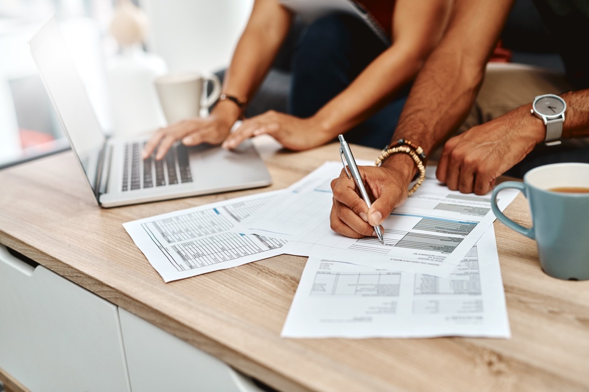 Cropped shot of a couple going over their finances together at home