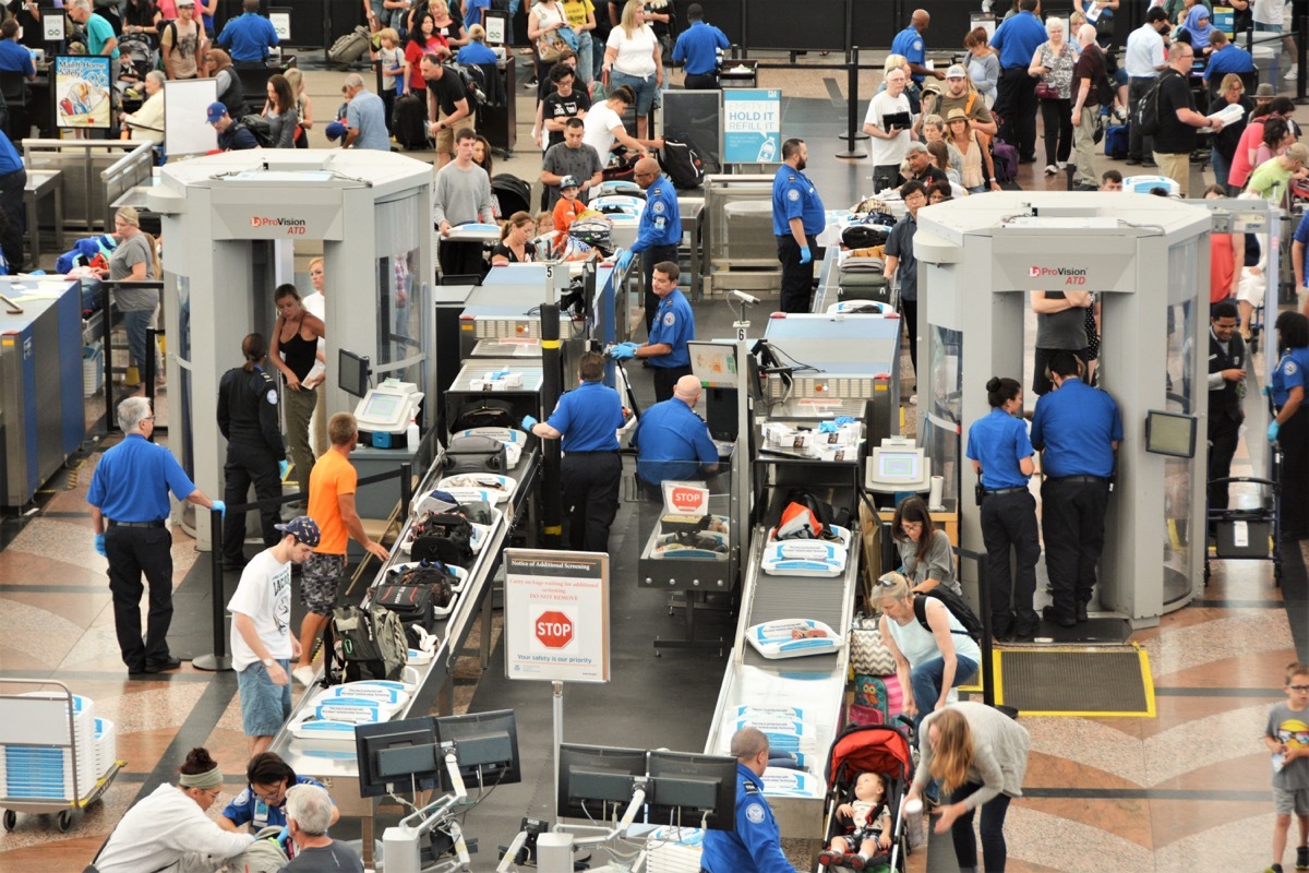 Travelers in long lines at Denver International Airport going thru the Transportation Security Administrations (TSA) security screening areas to get to their flights.