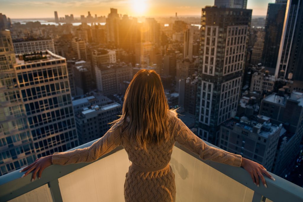 A woman looking out from her beautiful, luxury home.