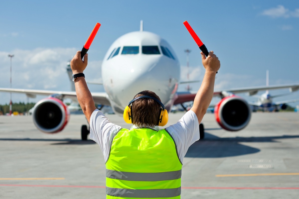 ground crew signaling to plane