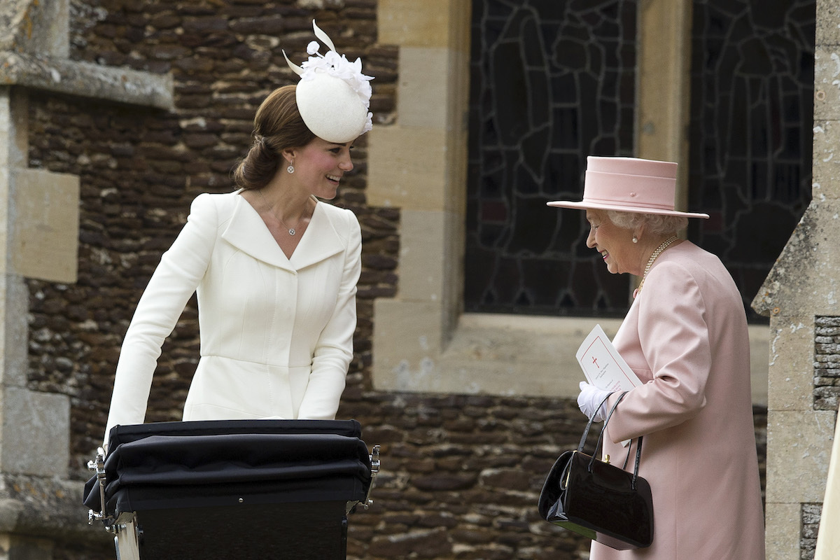  Queen Elizabeth II speaks to Catherine, Duchess of Cambridge, as she pushes in a pram Princess Charlotte of Cambridge at Church of St Mary Magdalene on the Sandringham Estate after the Christening of Princess Charlotte of Cambridge on July 5, 2015 in King's Lynn, England