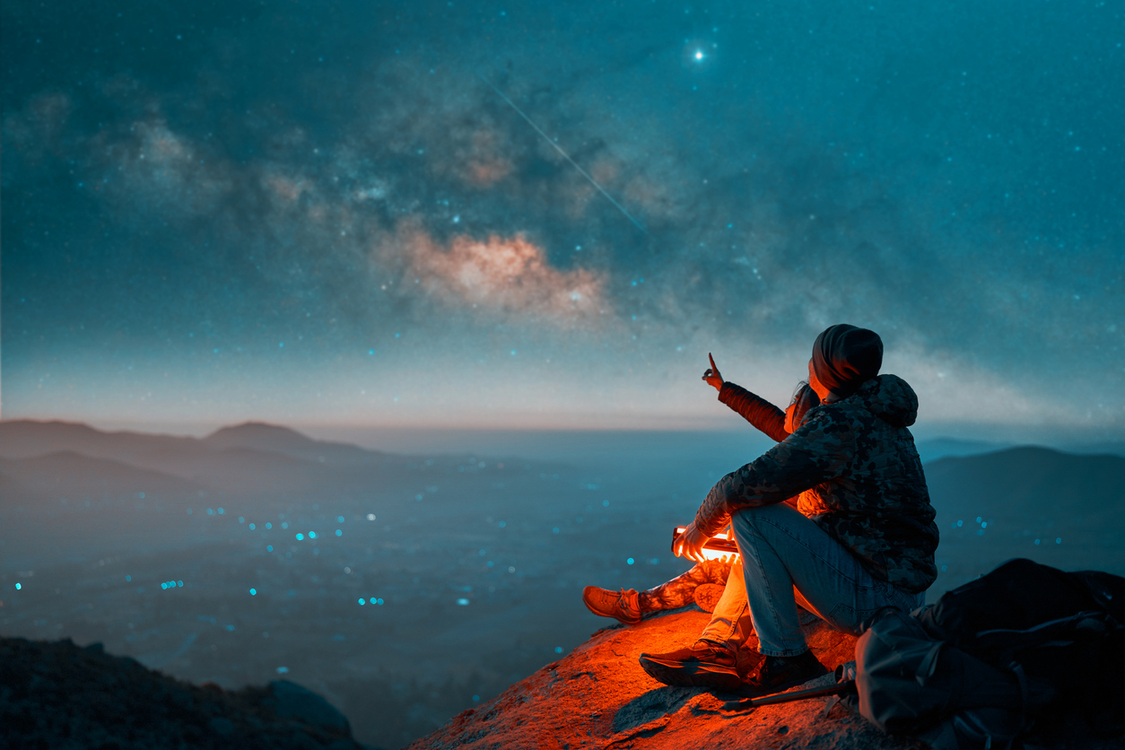 A couple looking at the Milky Way in the night sky