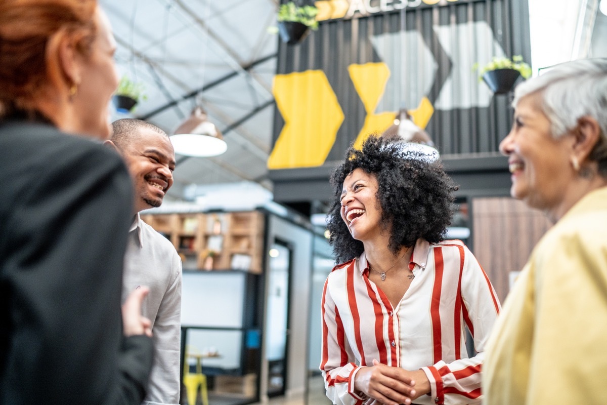 Happy coworkers talking at office