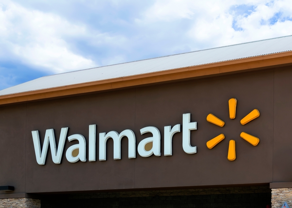 A Walmart sign from a storefront with a brown background