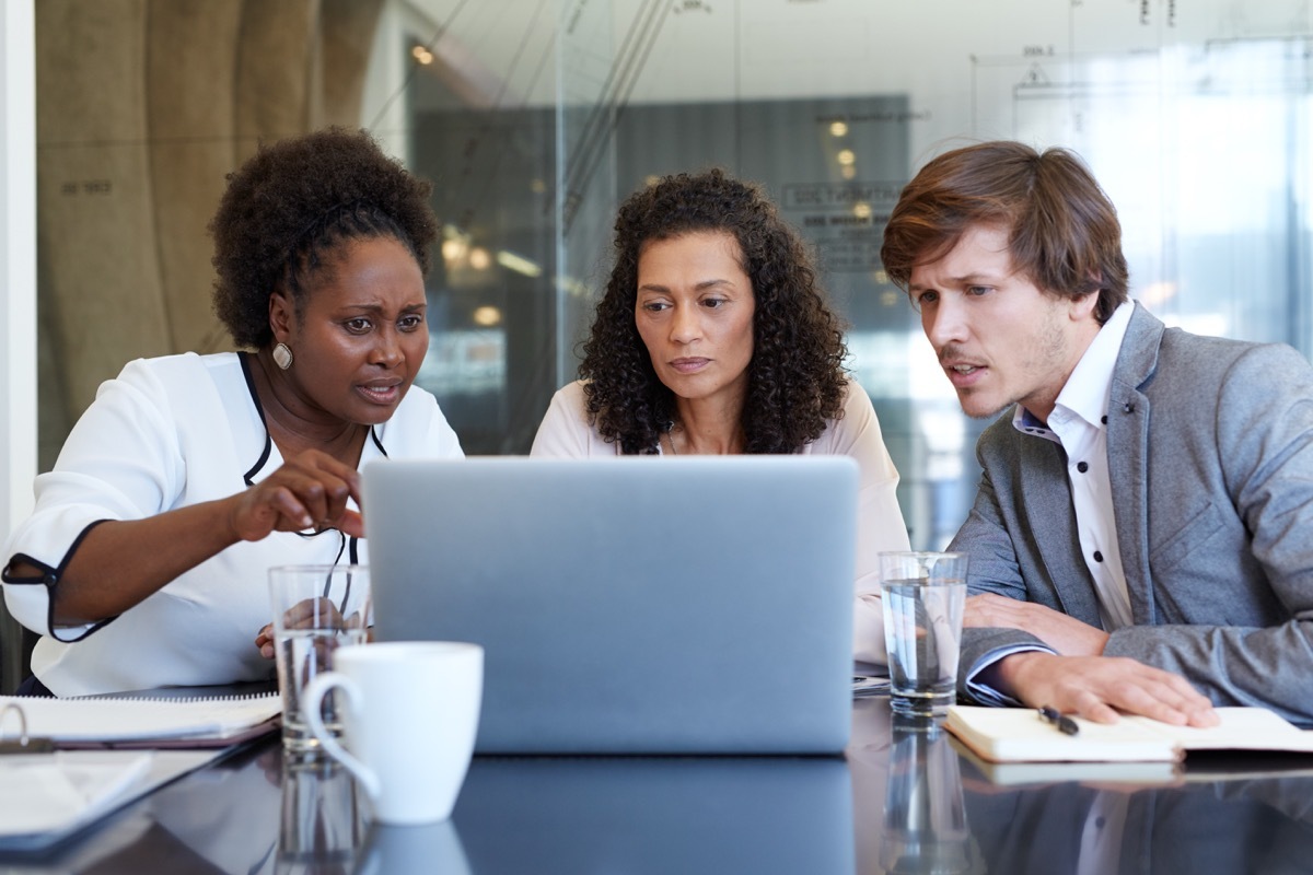 confused group of business workers staring at a screen