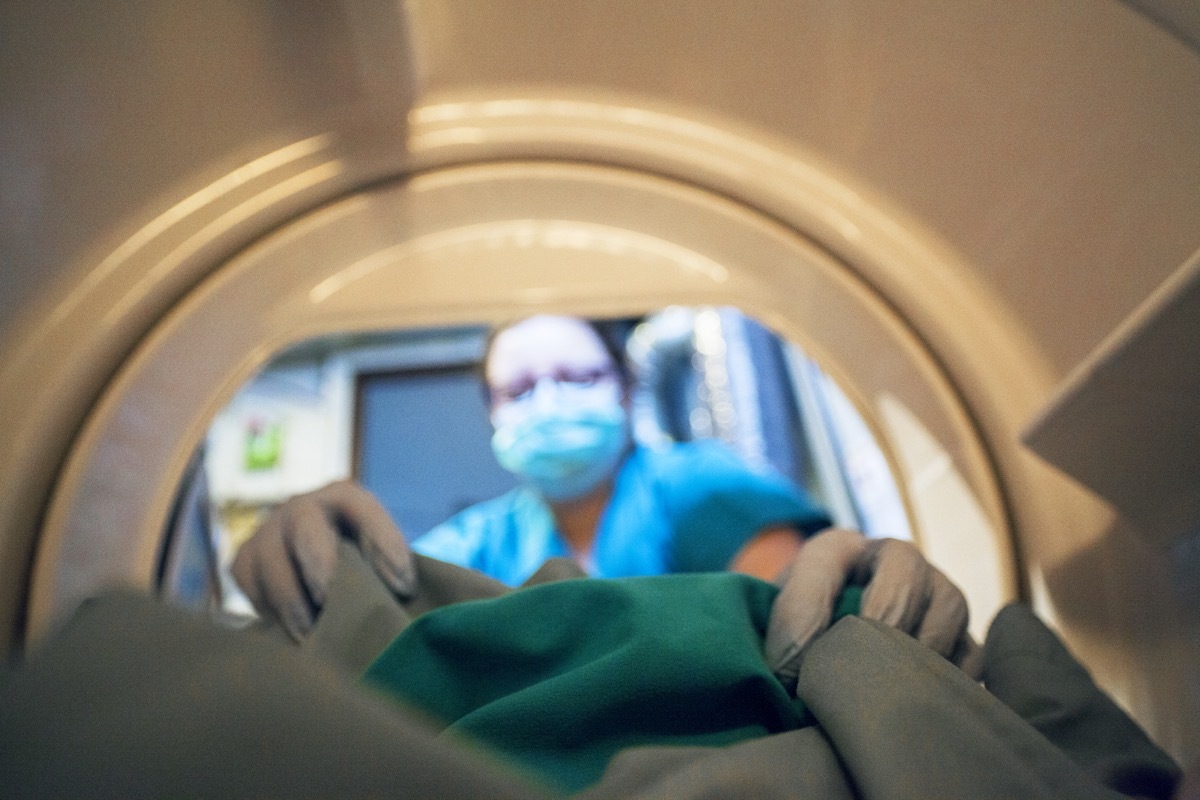 A nurse washing her scrubs.