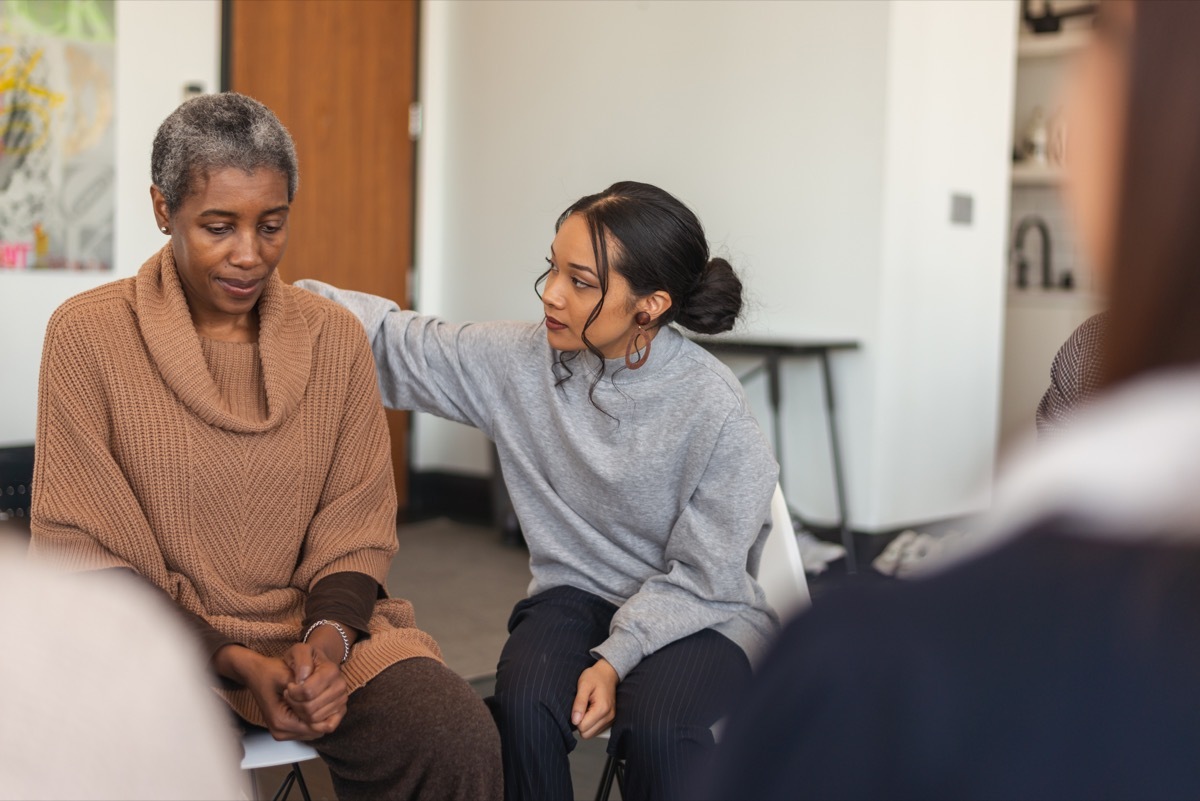 a group of women supporting each other in group therapy