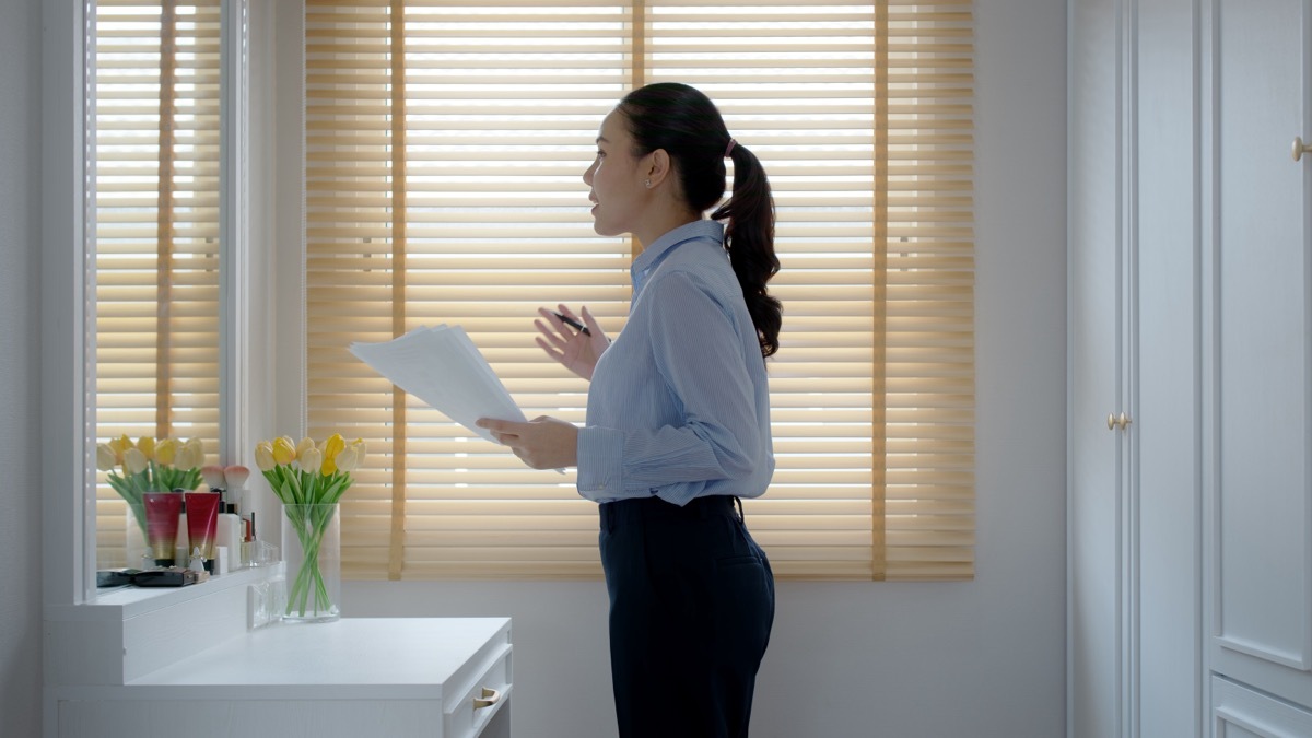 woman practicing speech in the mirror