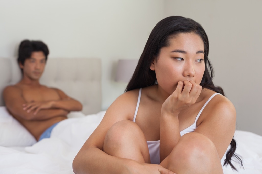 disappointed couple in bed