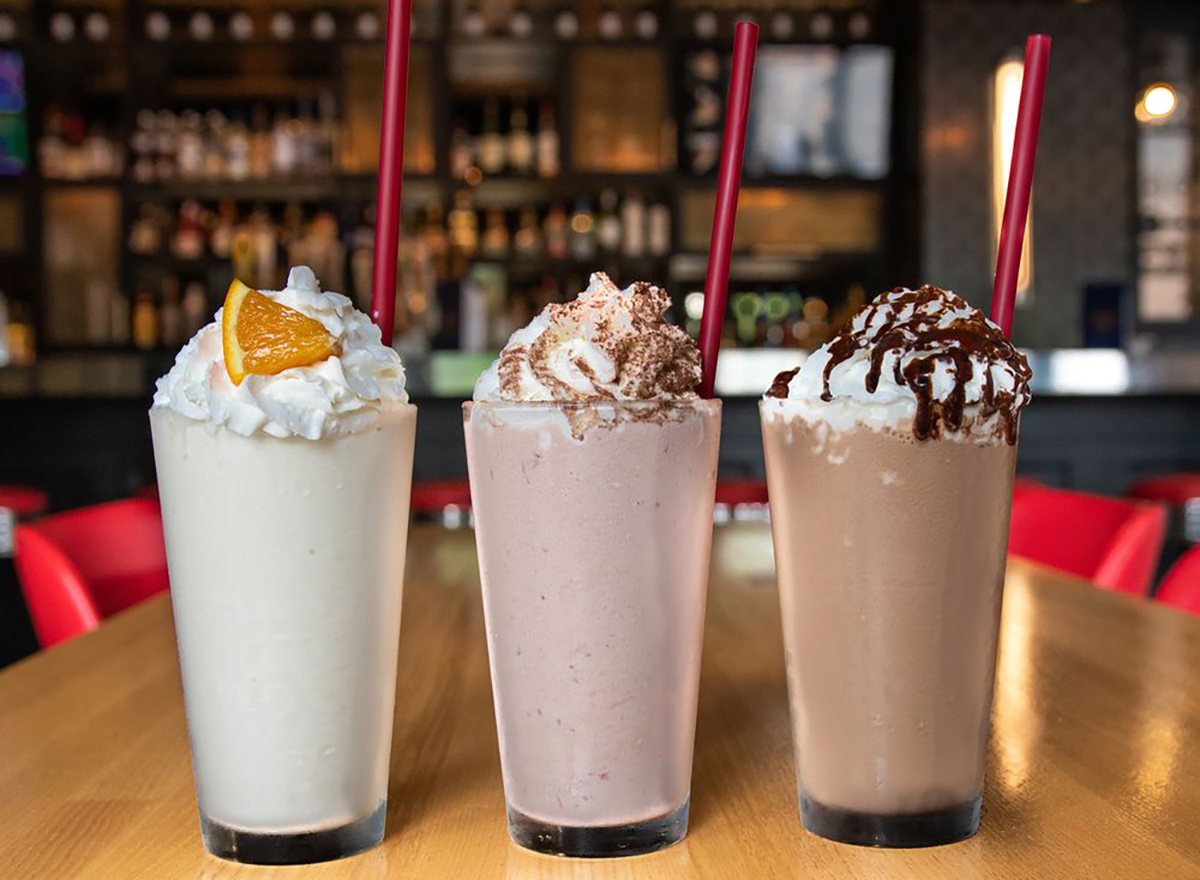 trio of spiked milkshakes on bar countertop