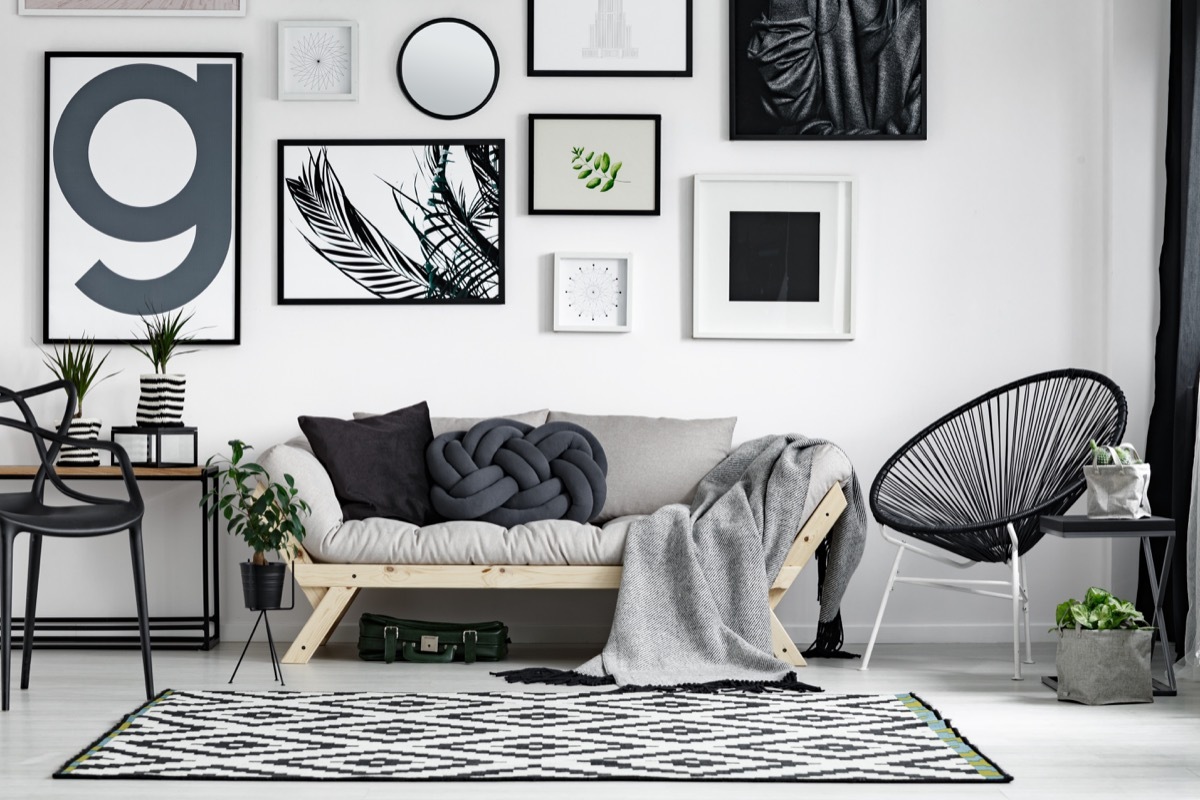 Wooden sofa with dark pillows in scandi style living room 