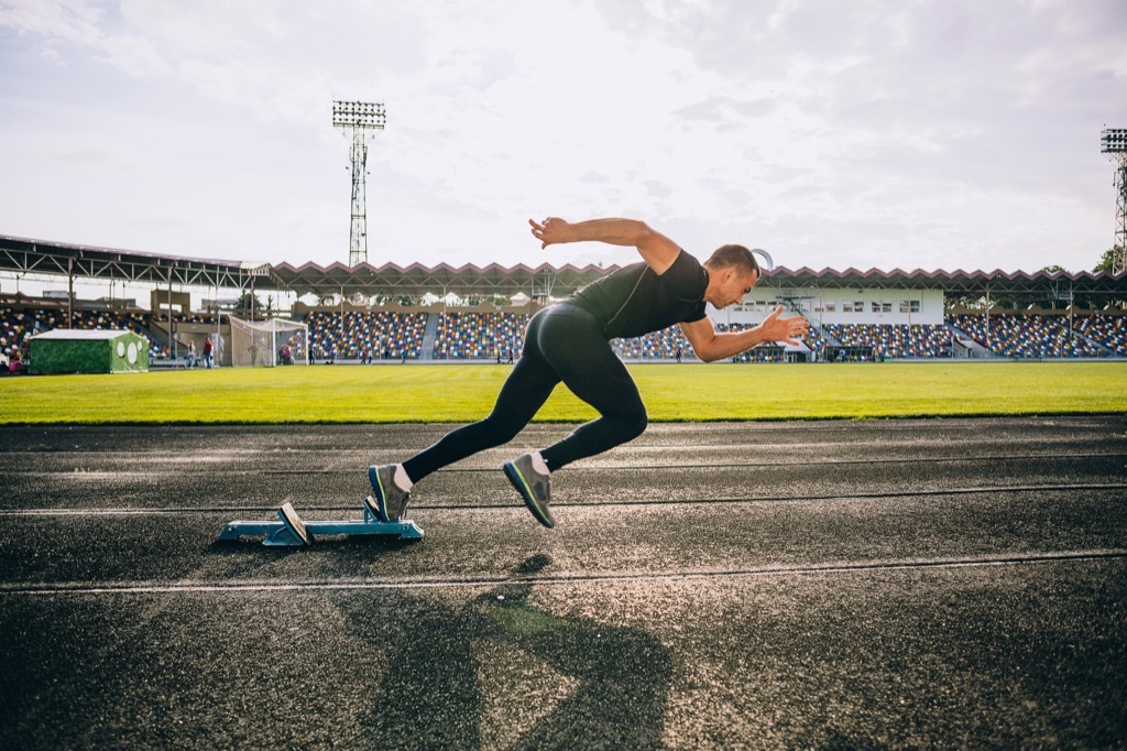 superhuman feats sprinting a mile on a track man and woman exercising cardio workouts for men over 40