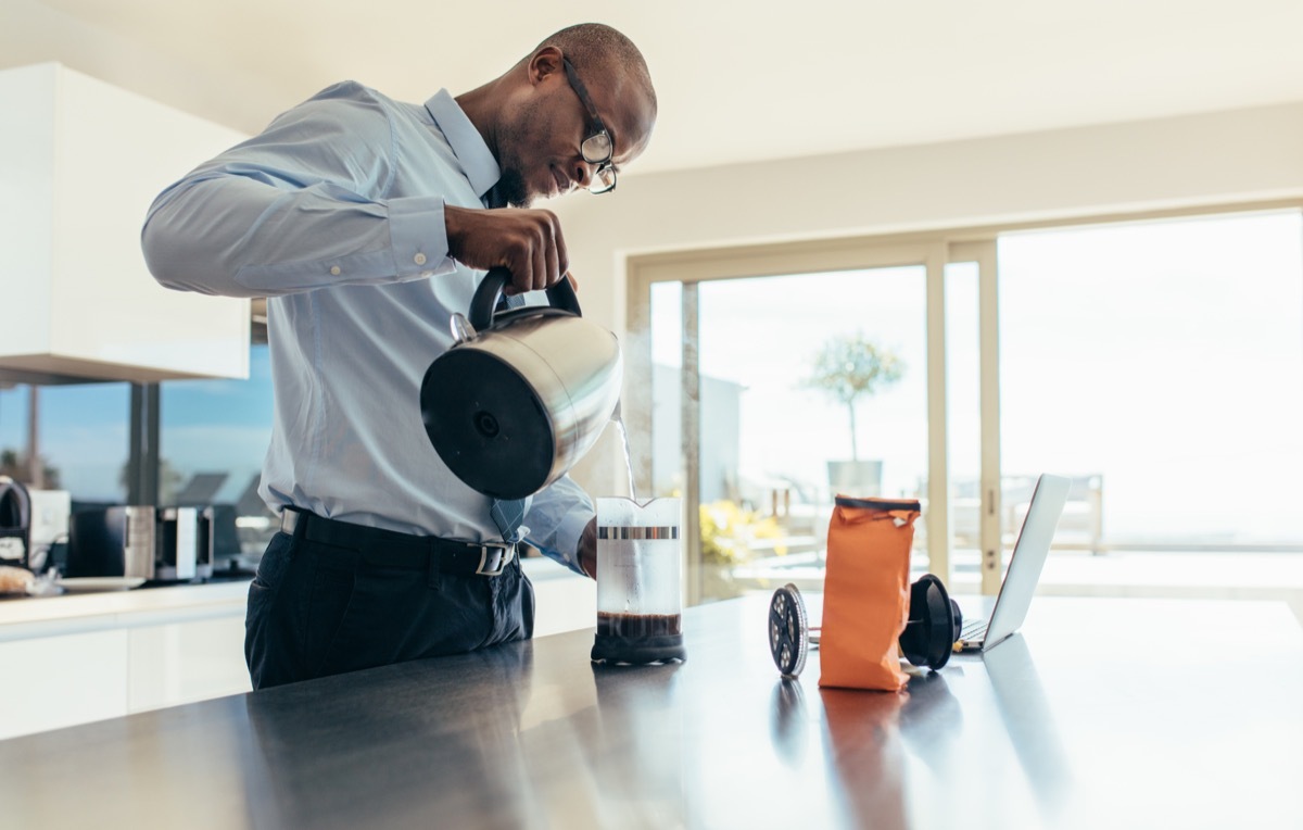 Man pouring from a coffee pot in the office, ways you're damaging teeth