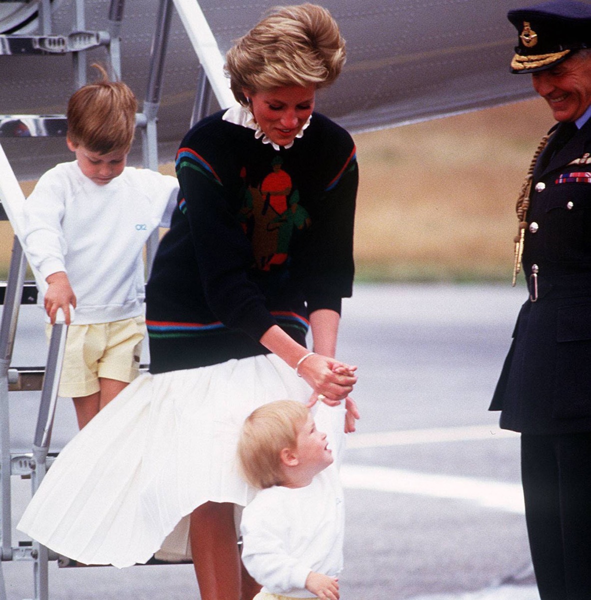 Diana and William and Harry getting off an airplane