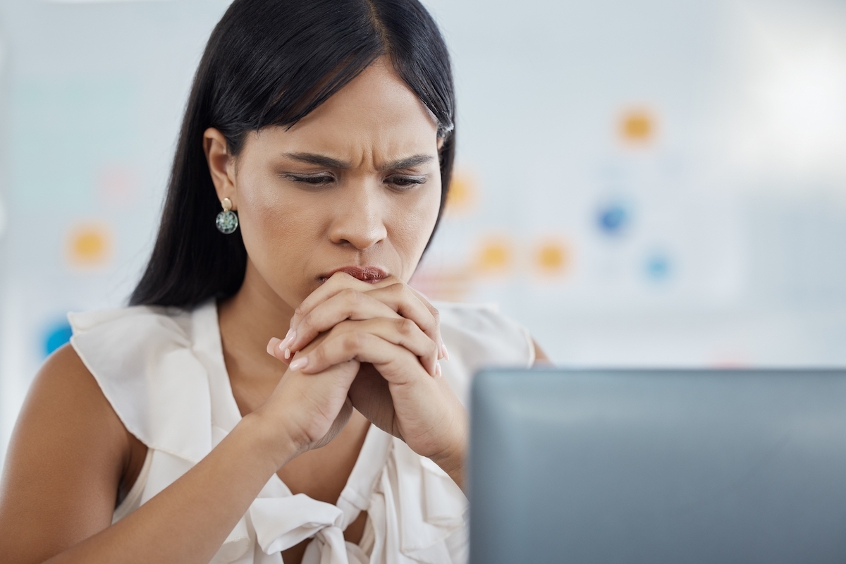 Woman looking at laptop concerned