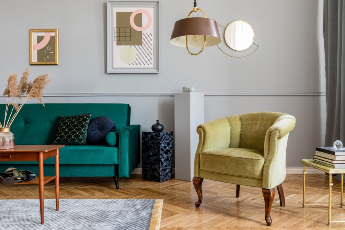 retro living room with green velvet chair and couch