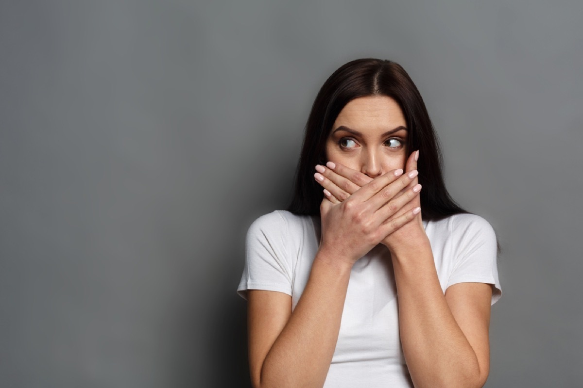 woman covering her mouth