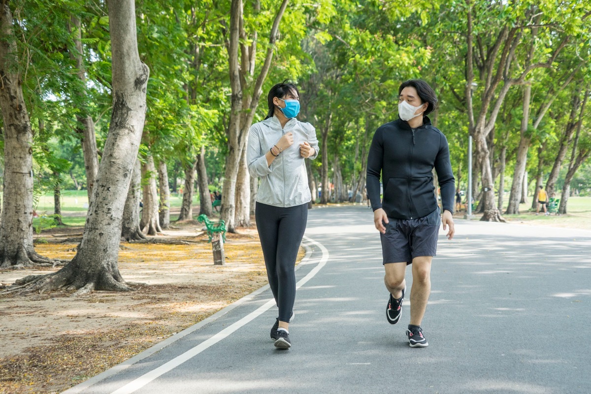 People wearing face masks while running in the park