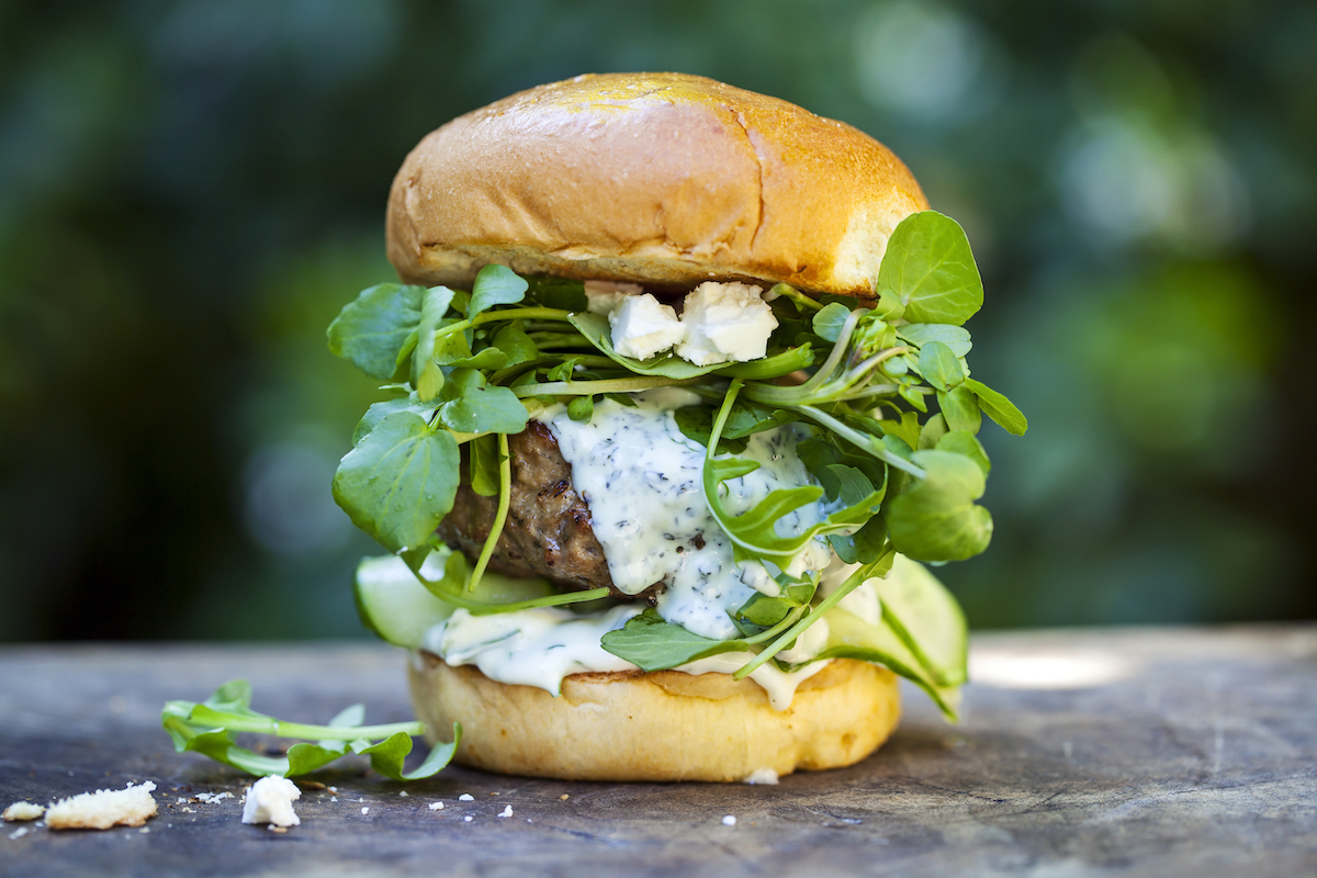 Lamb burger with pickled cucumber, fresh salad leaves and mint and garlic yogurt