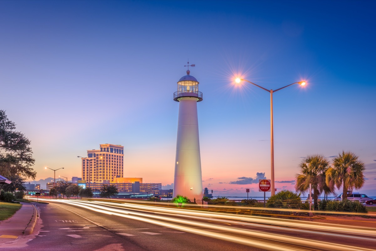 cityscape photos of a traffic on a street next to the Biloxi Lighthouse in Biloxi, Mississippi at night