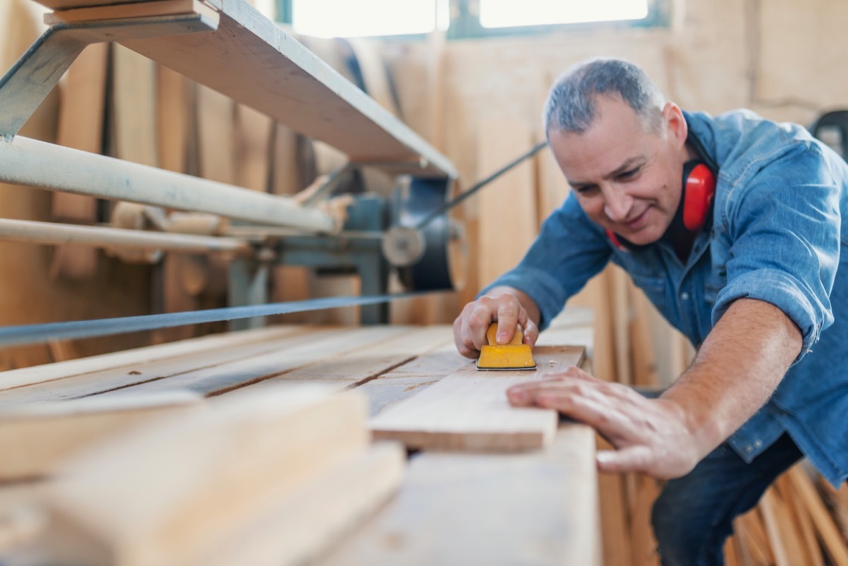 middle age man doing woodwork