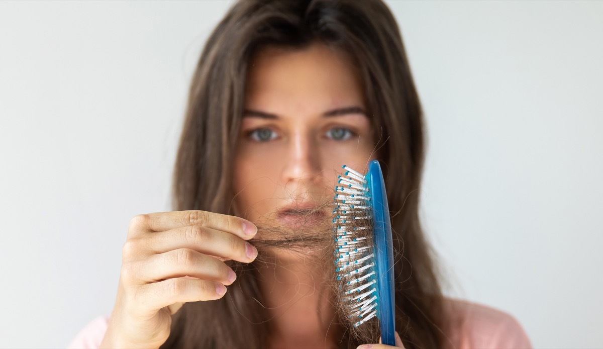 Young woman is very upset because of hair loss