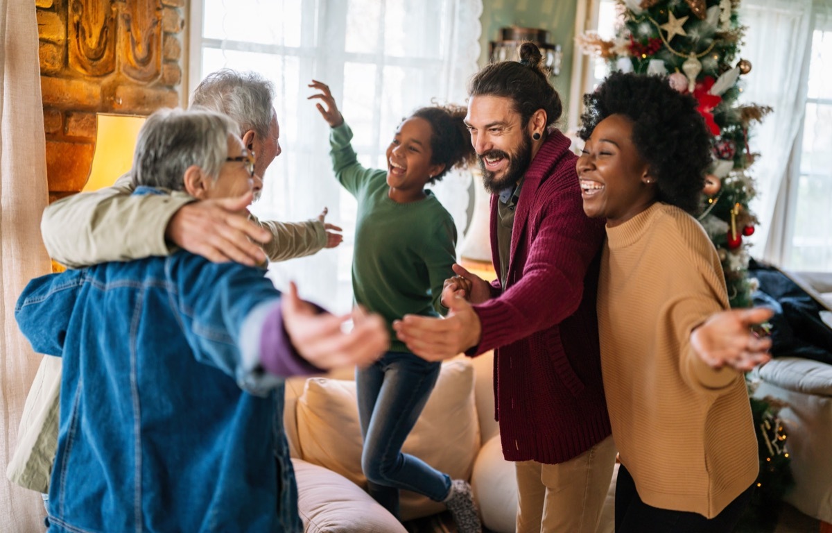 Happy multiethnic multi-generational family enjoying Christmas time together. People love concept.