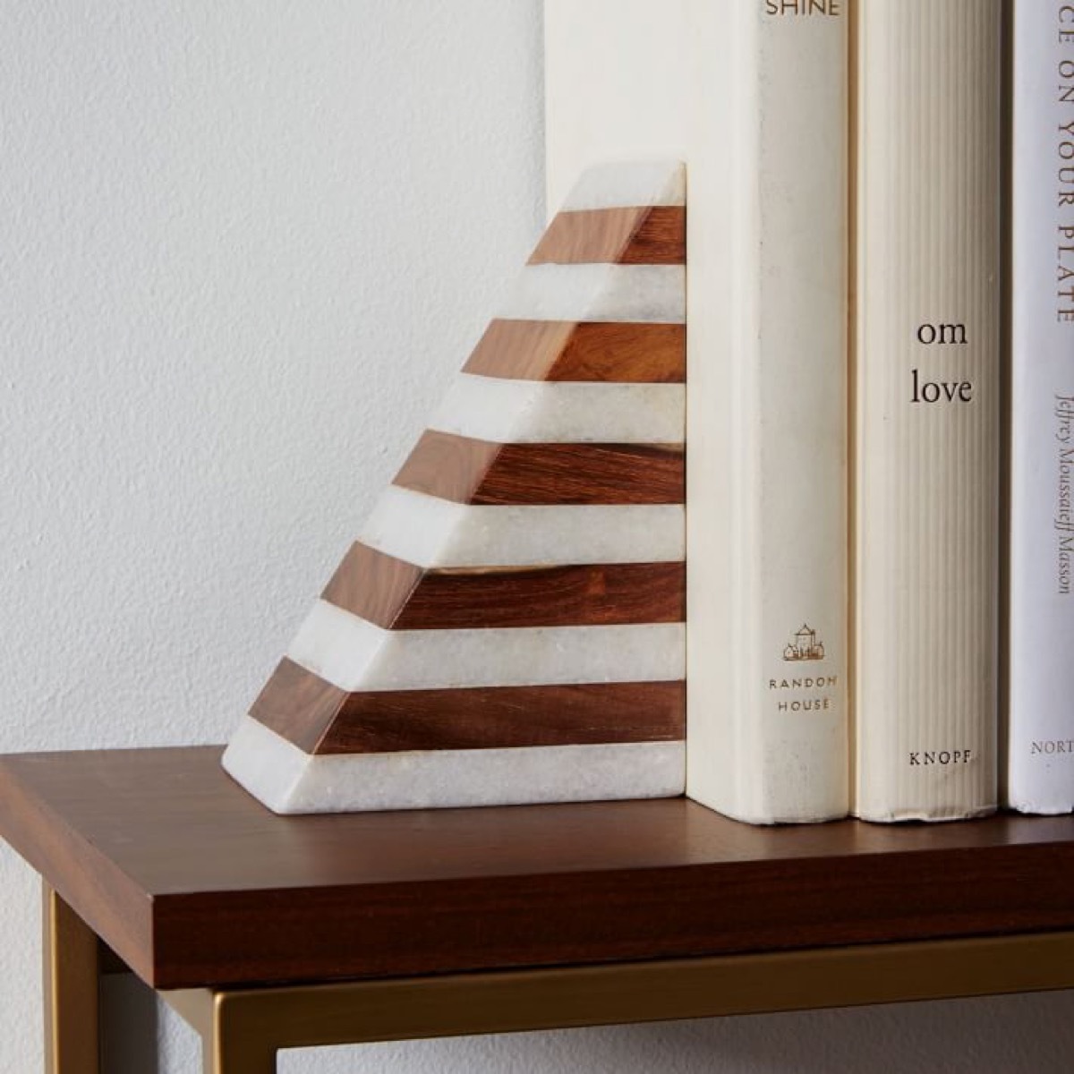 wood and marble book end holding books