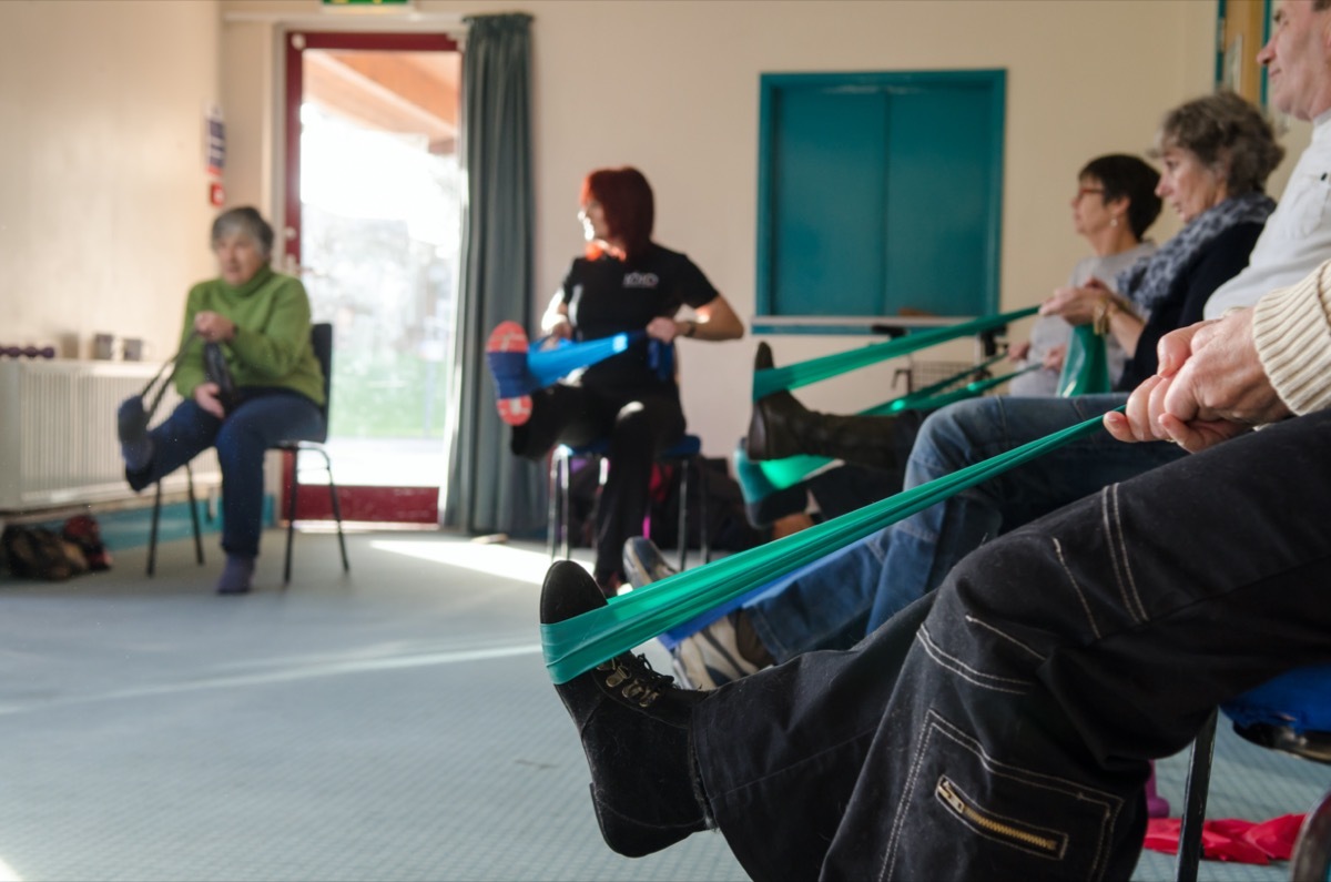 Occupational therapy instructor provides training exercises for multiple sclerosis patients at health center