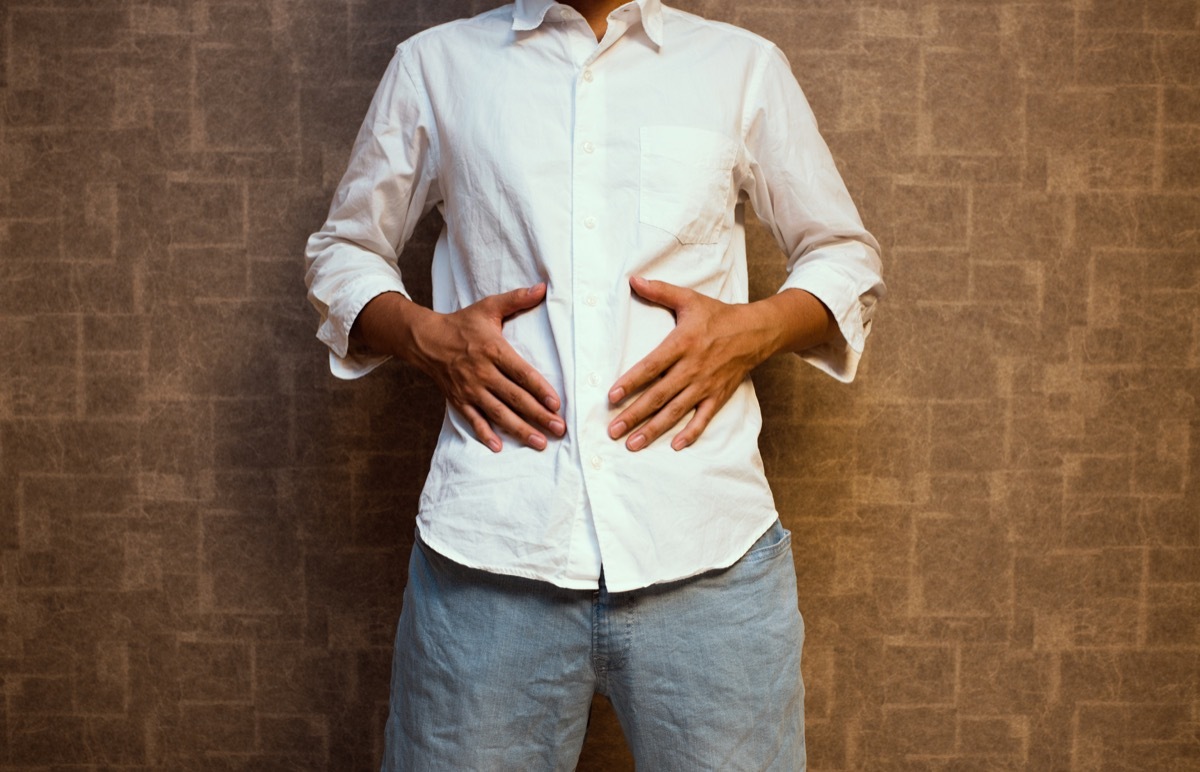 Man holding his stomach with hunger pangs