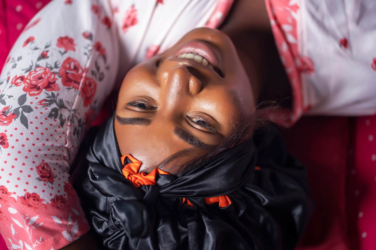 Top view of woman lying in bed and smiling