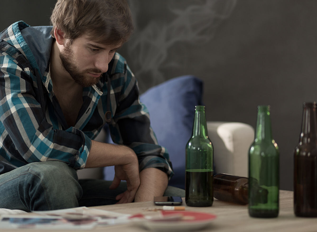 man staring at table of beers - how does alcohol affect the brain