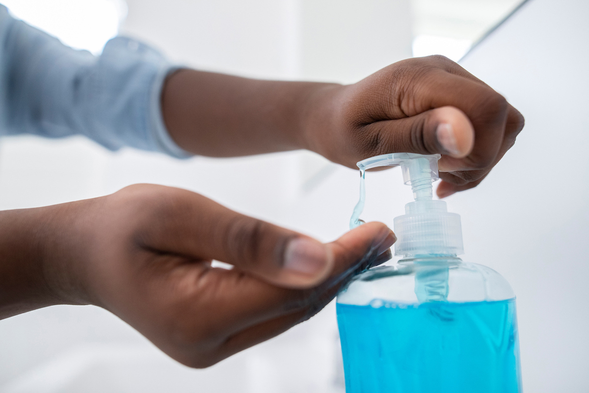 Close Up Of Boy Washing Hands With sanitizer At Home To Prevent Infection