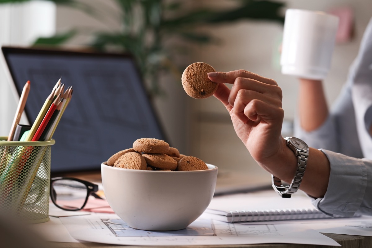 eating snack cookies at desk