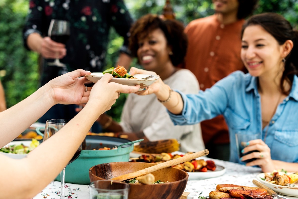 Friends having pot-luck dinner