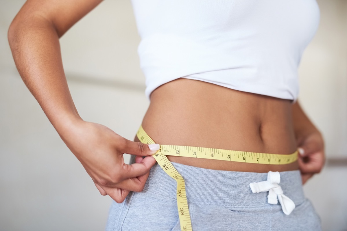 Woman Measuring Her Waist for Weight Gain