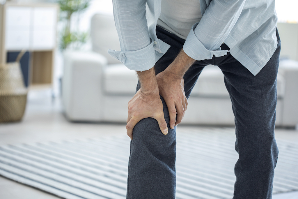 old elderly man suffering from knee pain