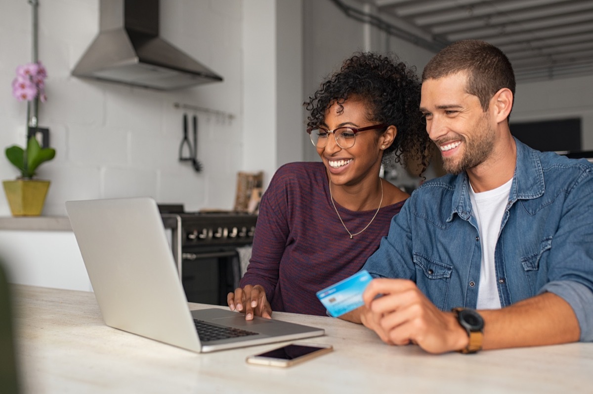 Happy multiethnic couple making online payment