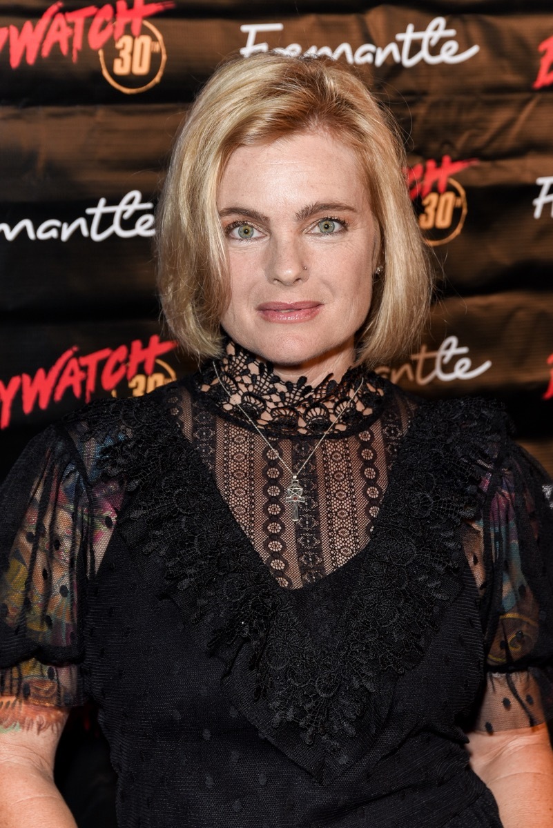 Erika Eleniak in black dress on red carpet