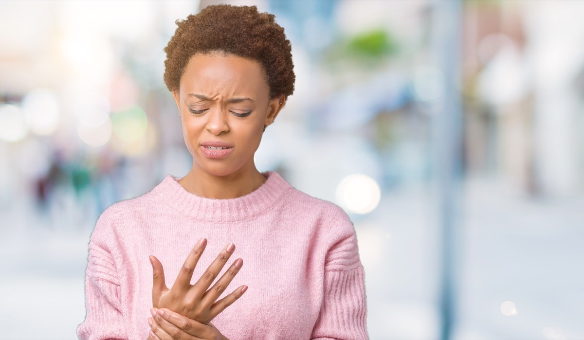 woman rubbing her hand outside in winter