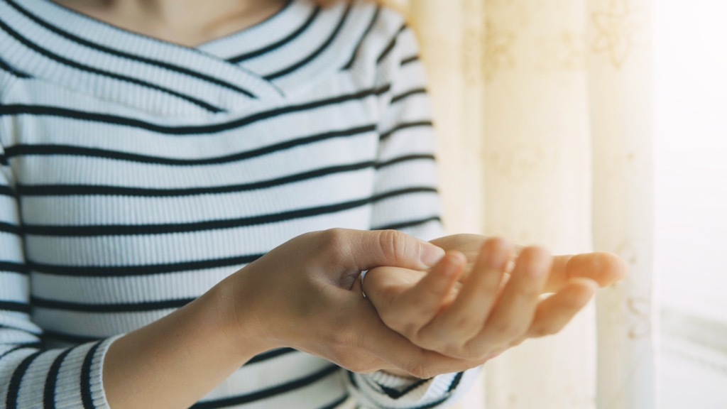 woman having a bad hand cramp