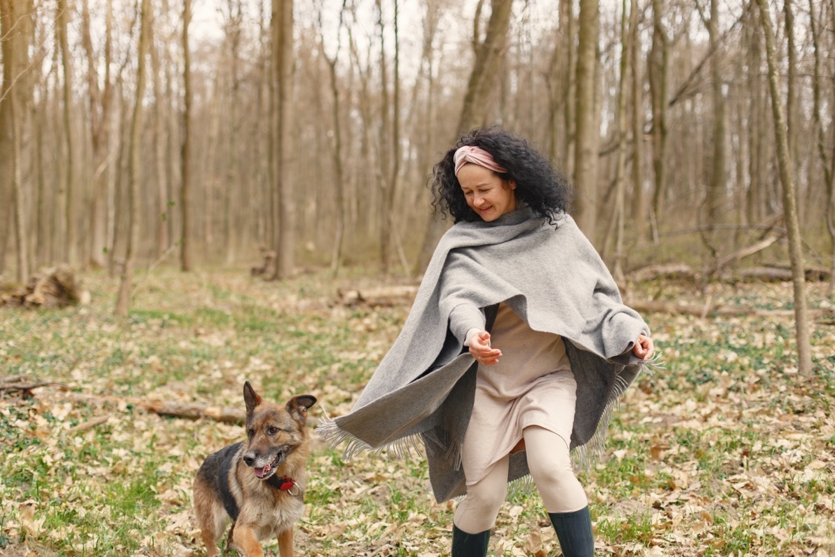 Woman in woods with dog