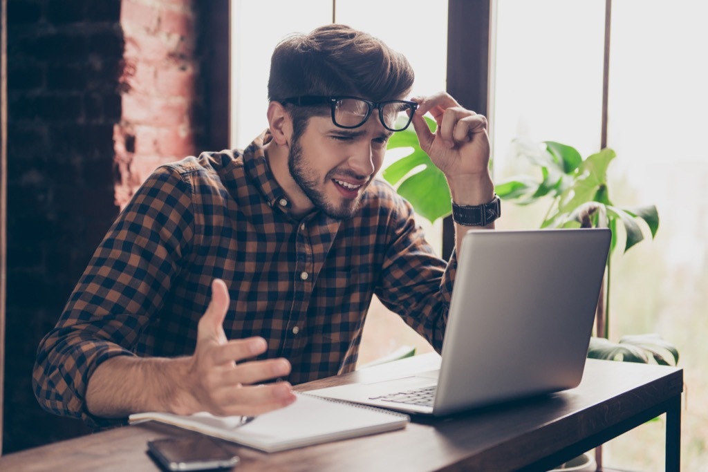 man shocked computer