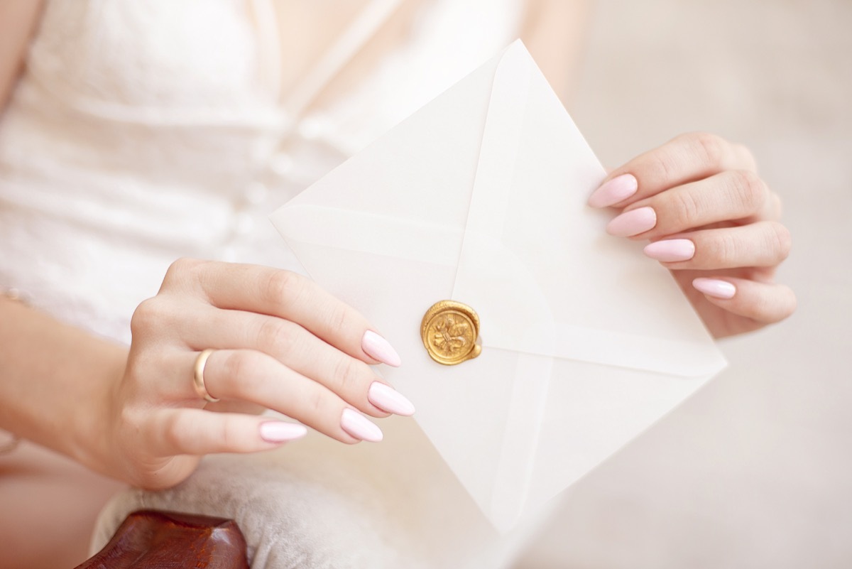 woman with rsvp invitation in hand