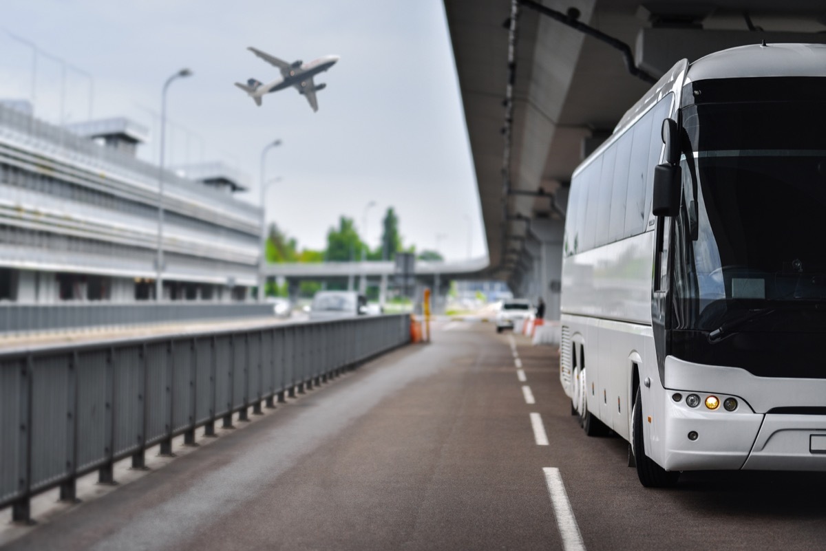 An airport shuttle bus parked at a terminal