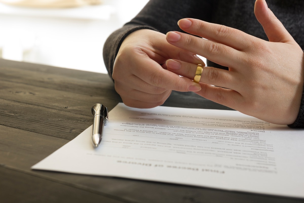 Woman removes wedding ring while filing for divorce