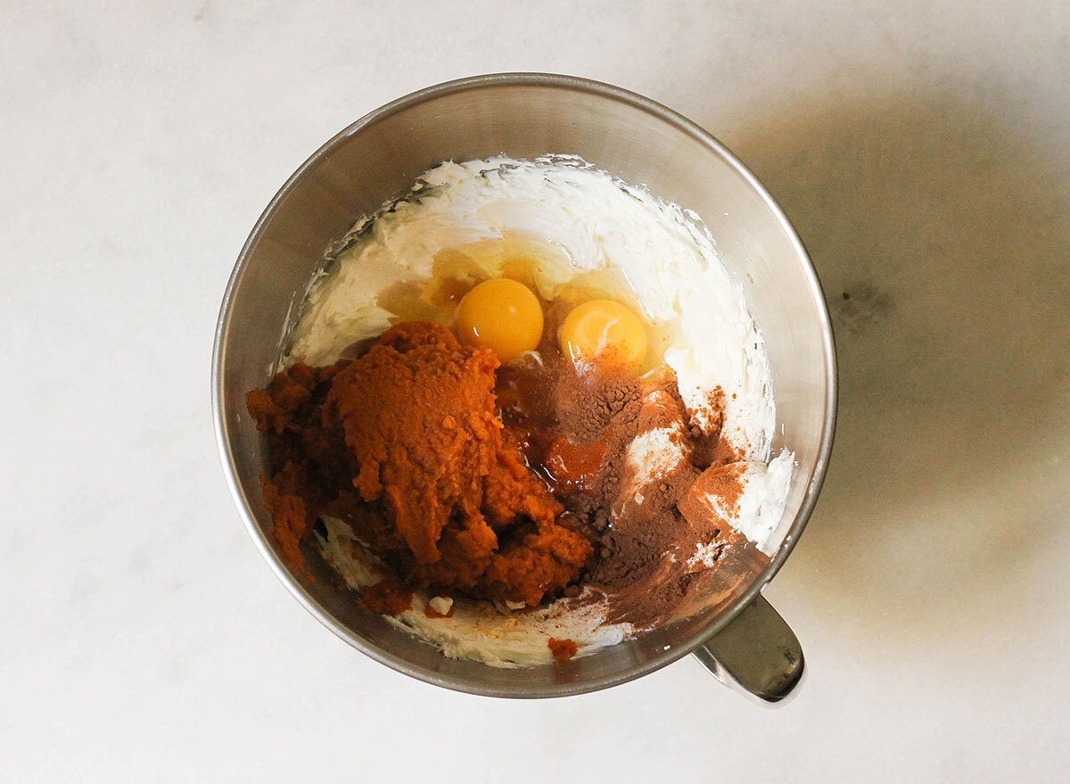 Mixing together ingredients for pumpkin cheesecake