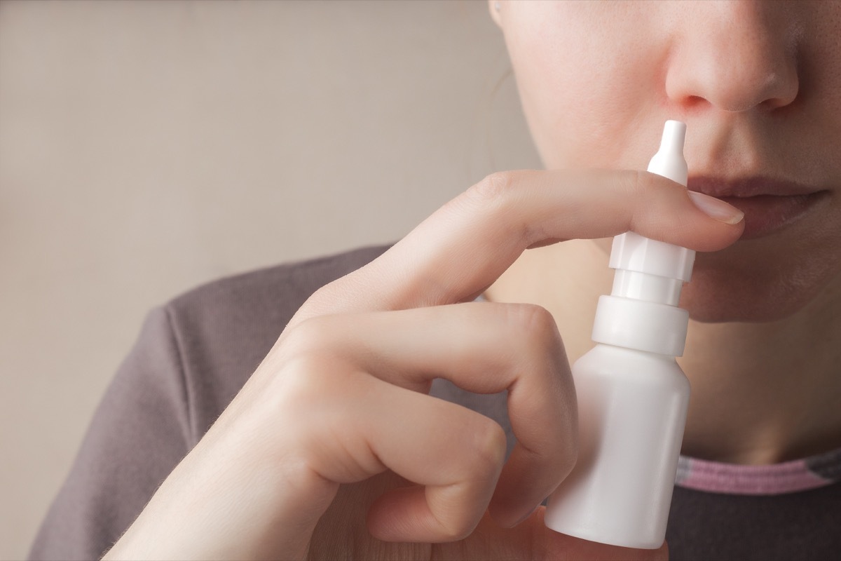 Woman Using Nasal Spray