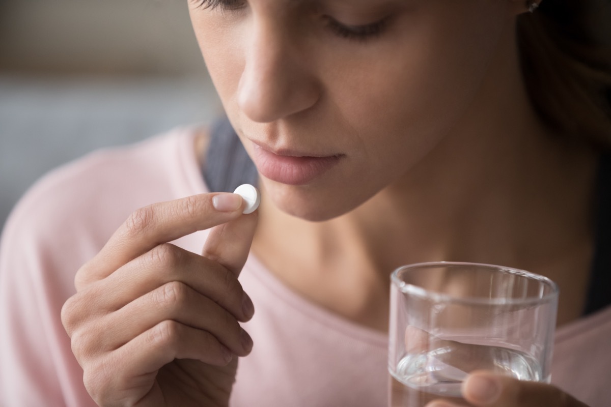 Woman taking antacid pills